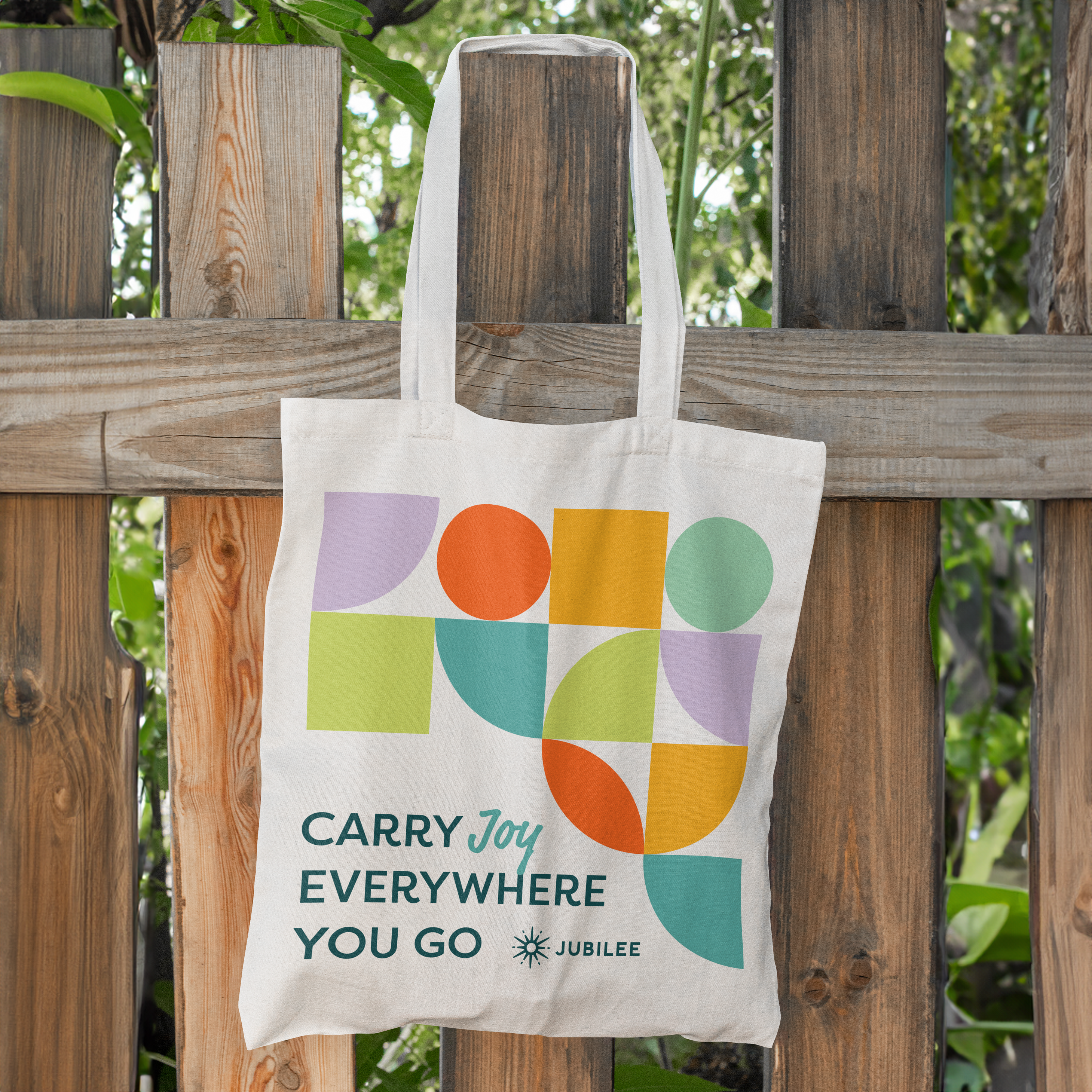 Branded Joyfest event tote bag design hanging on fence for master planned community Jubilee designed by ST8MNT